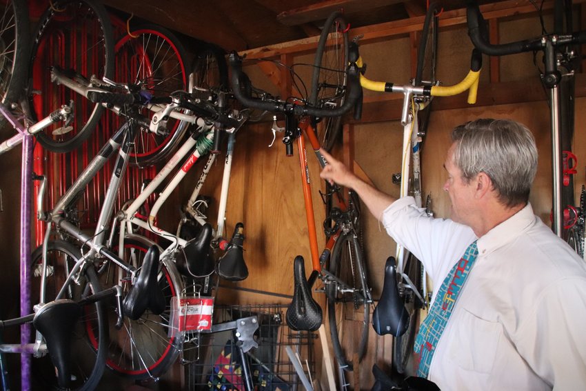 Ted Schultz points to the numerous bikes he has accumulated over the years.
